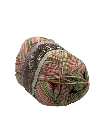 Spring multicoloured "Apple Blossom" ball of superfine 4 ply Merino wool on white background