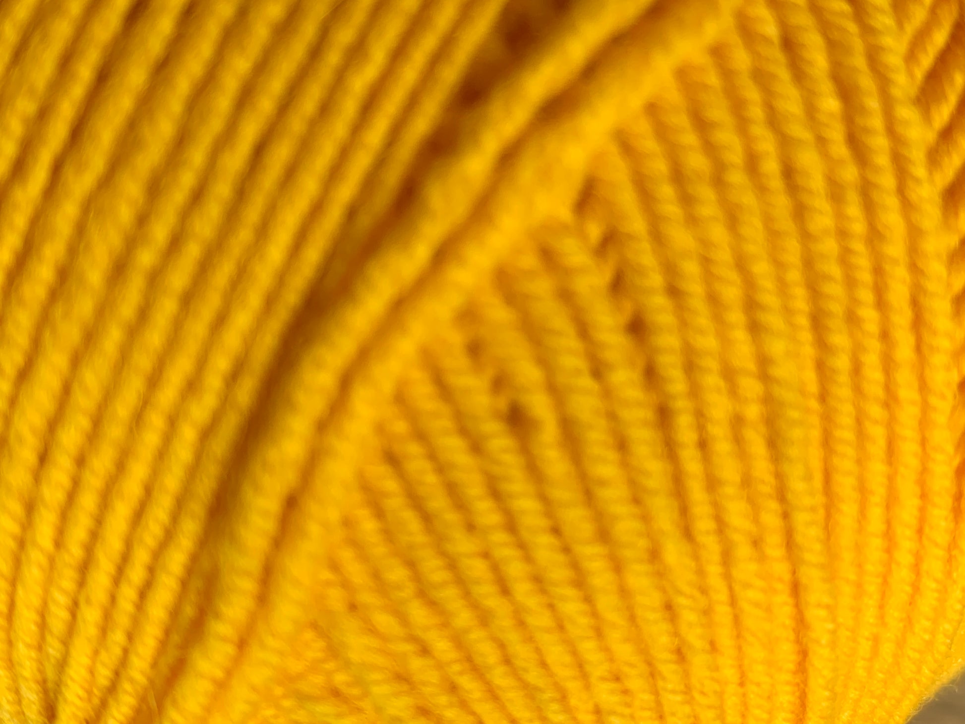 Yellow "Everlasting" ball of superfine 4 ply Merino closeup.