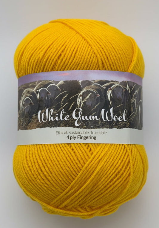 Bright golden yellow "Everlasting" ball of superfine 4 ply Merino wool on white background