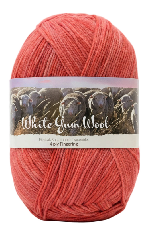 Warm mid-pink coloured hues "Rose Hip" ball of superfine 4 ply Merino on white background