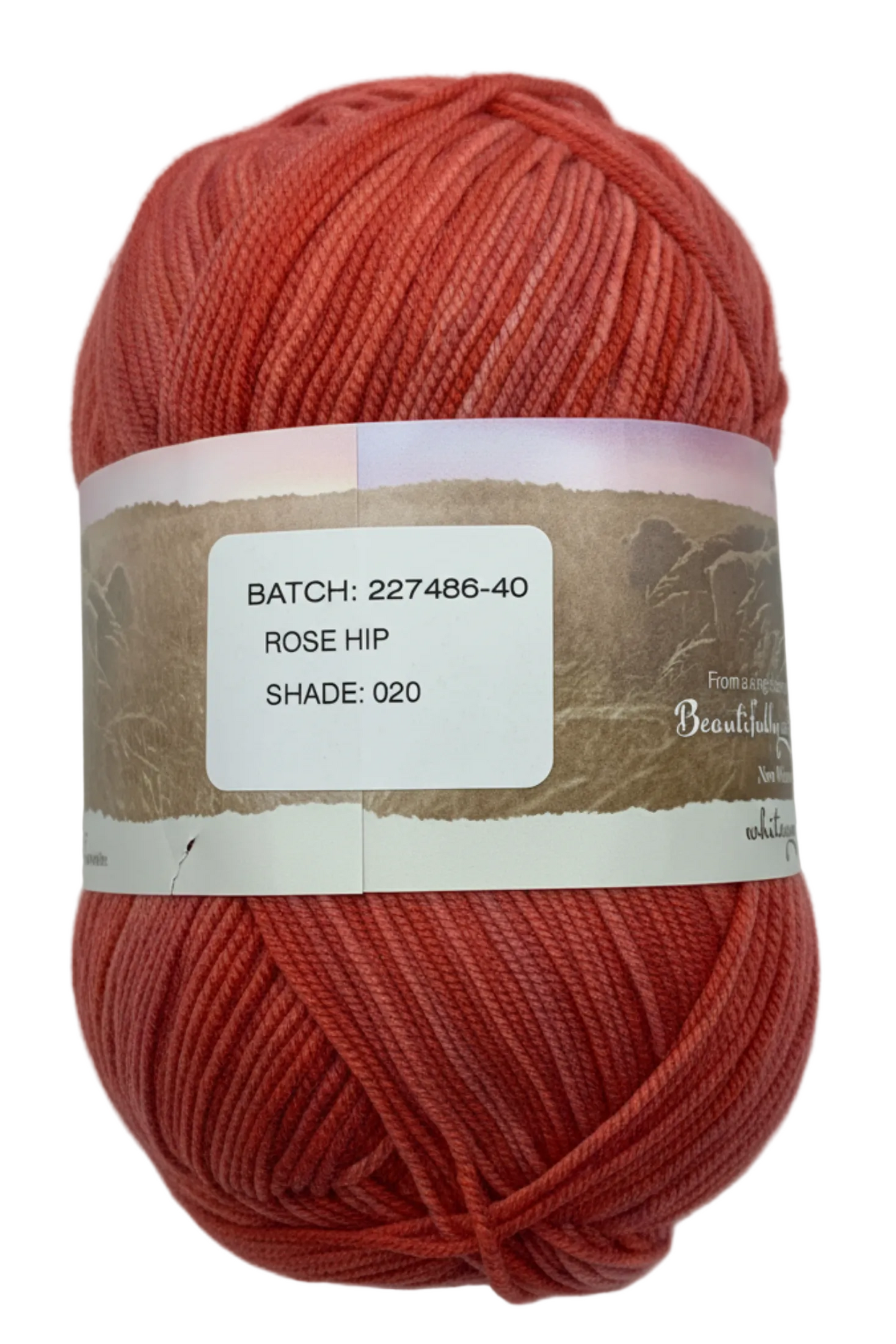 Warm mid-pink hues "Rose Hip" coloured ball of superfine 4 ply Merino on white background