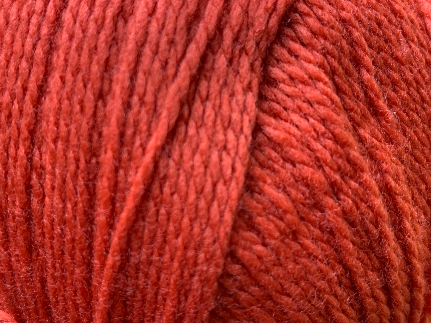 Close up of Superfine Merino 4 ply  in Red "Flame" colour