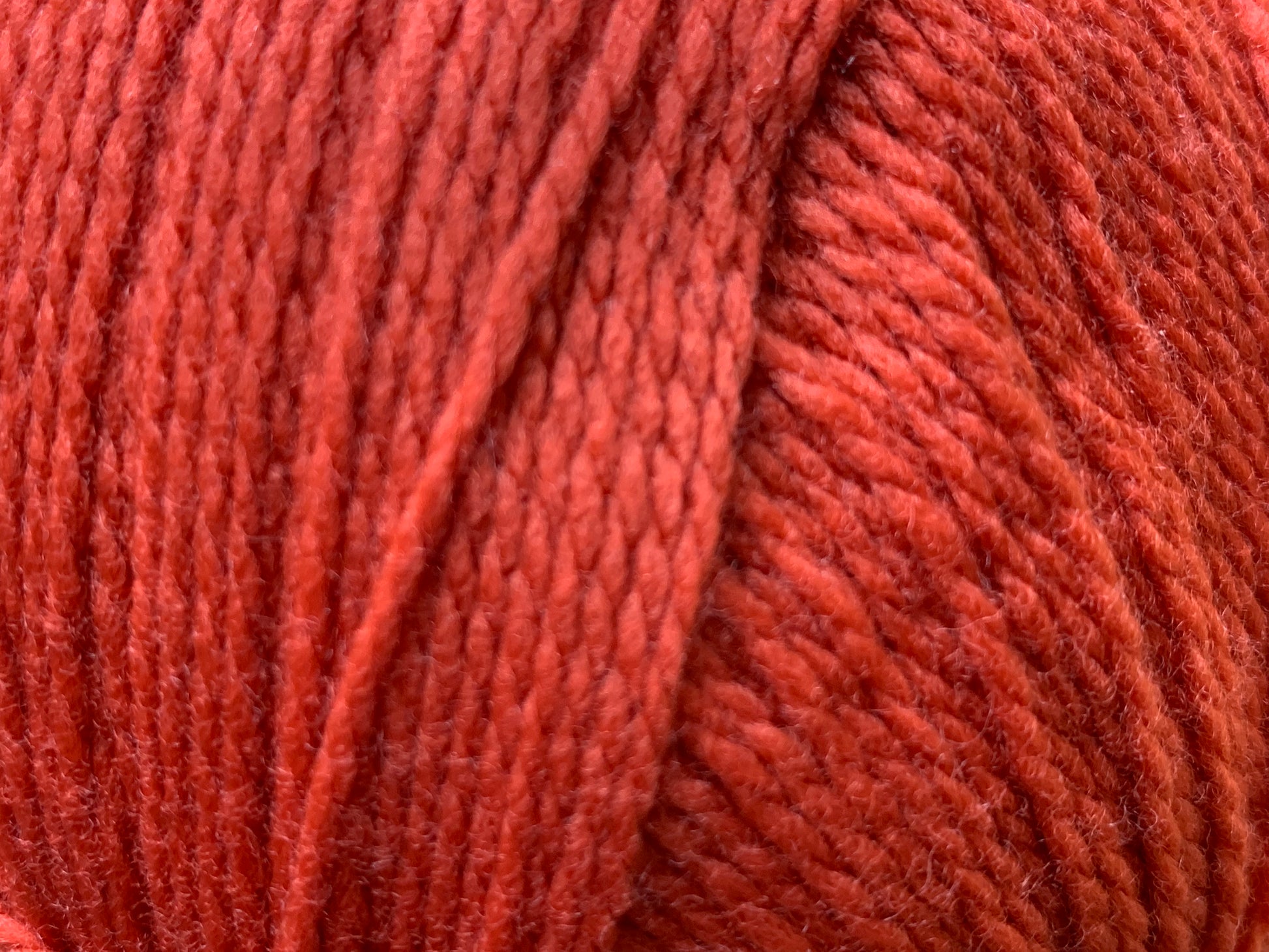 Close up of Superfine Merino 4 ply  in Red "Flame" colour